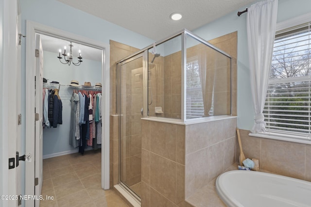 full bathroom with tile patterned flooring, a stall shower, and a wealth of natural light