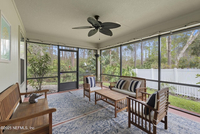 sunroom / solarium with a healthy amount of sunlight and a ceiling fan