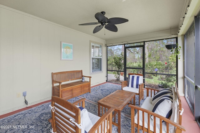 sunroom / solarium featuring a ceiling fan