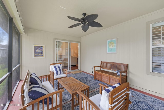 sunroom / solarium featuring ceiling fan