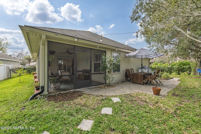 back of house featuring a yard, a patio, a fenced backyard, and a sunroom