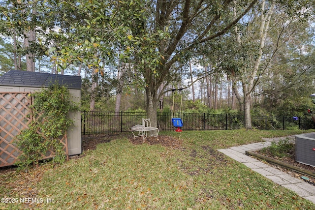 view of yard featuring a storage unit, cooling unit, an outbuilding, and a fenced backyard