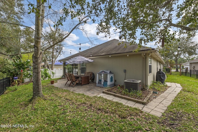 rear view of property featuring a yard, a patio, a fenced backyard, and stucco siding