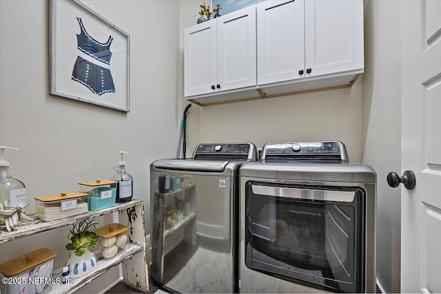 washroom with washer and dryer and cabinet space