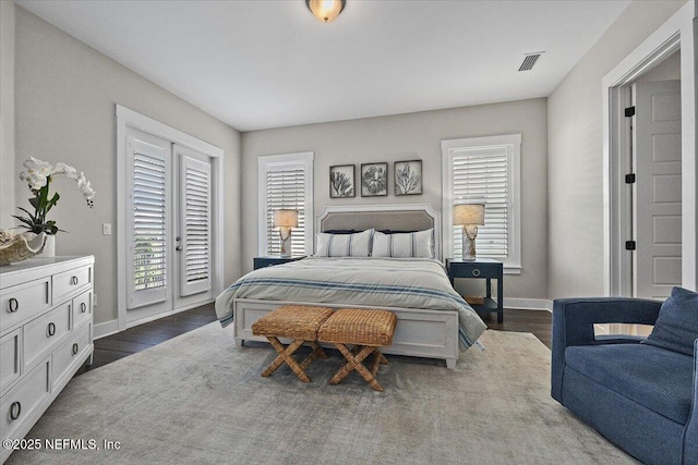 bedroom featuring access to exterior, baseboards, dark wood-style flooring, and visible vents