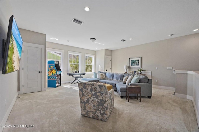 carpeted living area featuring recessed lighting, baseboards, and visible vents