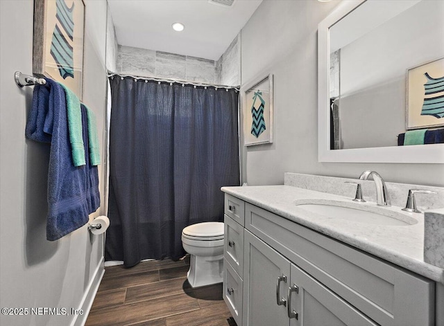 full bathroom featuring vanity, a shower with curtain, toilet, and wood finished floors