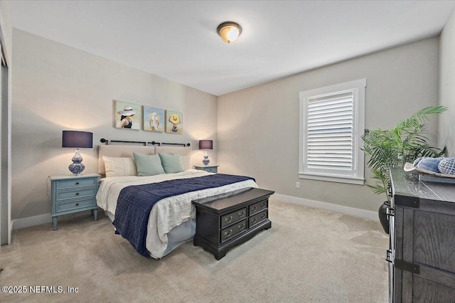 bedroom featuring baseboards and light carpet