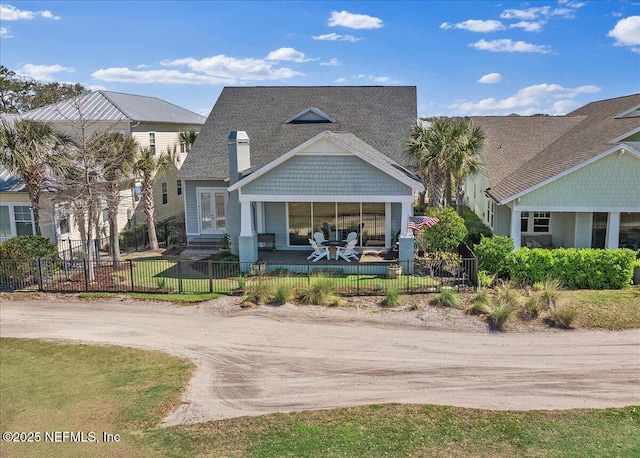 view of front of home with a front yard, driveway, and a fenced front yard