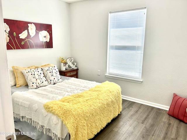 bedroom with wood finished floors and baseboards