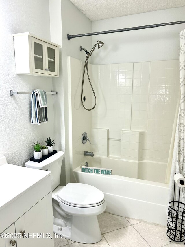 bathroom featuring toilet, vanity, shower / bath combo, tile patterned floors, and a textured ceiling