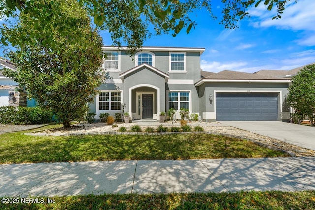 traditional-style home with concrete driveway, an attached garage, and stucco siding