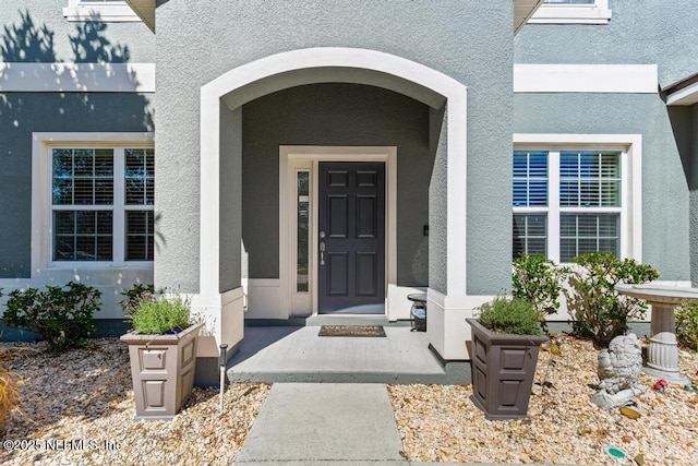 property entrance featuring stucco siding