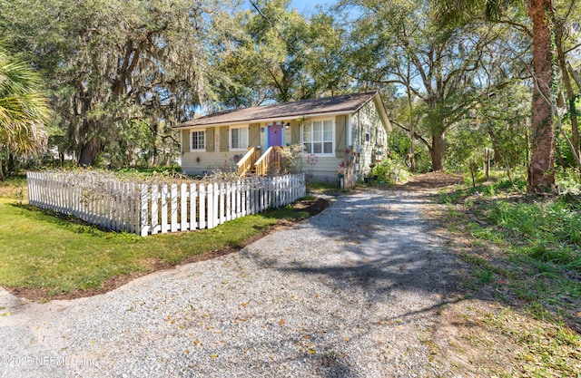 view of front of property featuring a fenced front yard and driveway