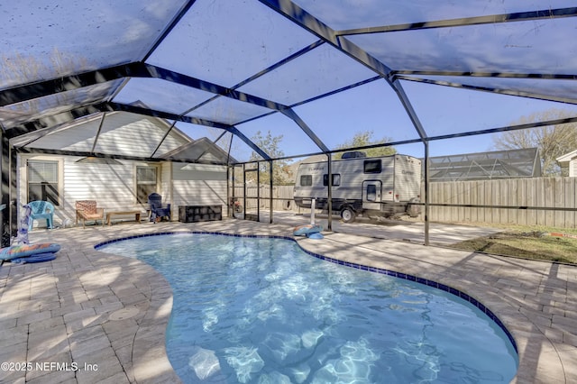 view of swimming pool with a patio area, a fenced backyard, glass enclosure, and a fenced in pool