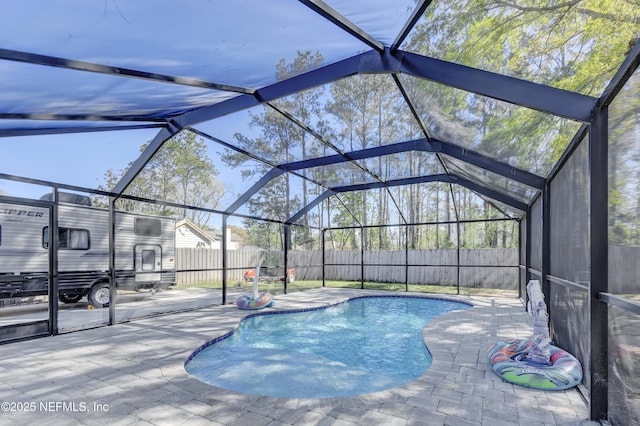 view of pool featuring a patio area, a fenced backyard, a fenced in pool, and a lanai