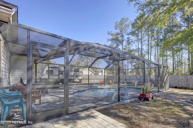 view of patio / terrace with a lanai, a fenced backyard, and a fenced in pool