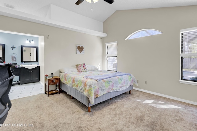 bedroom featuring light carpet, baseboards, a ceiling fan, connected bathroom, and vaulted ceiling