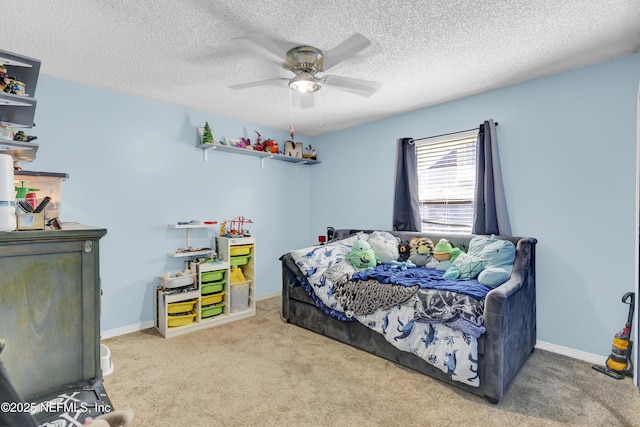 bedroom featuring baseboards, a textured ceiling, a ceiling fan, and carpet flooring