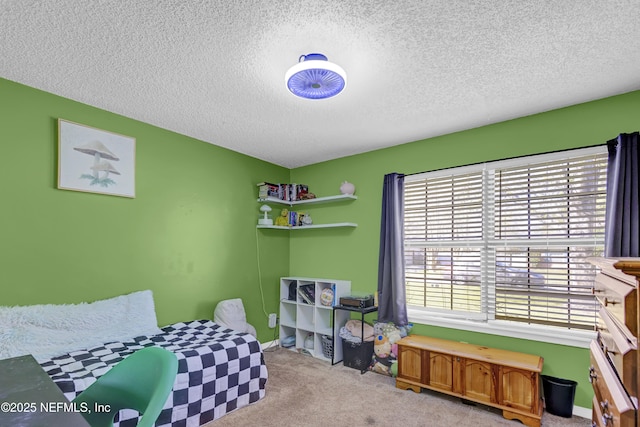 bedroom with a textured ceiling and light colored carpet