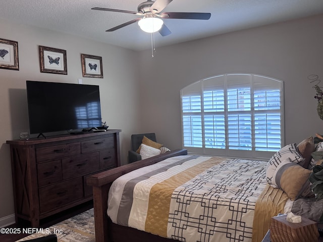 bedroom with a textured ceiling and ceiling fan