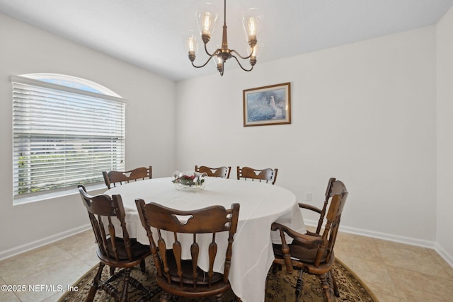 dining space featuring baseboards, plenty of natural light, and an inviting chandelier