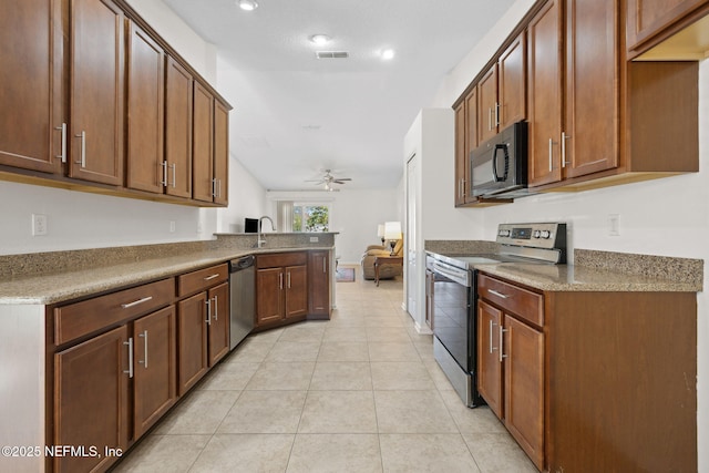 kitchen with light tile patterned floors, visible vents, a ceiling fan, stainless steel appliances, and a sink