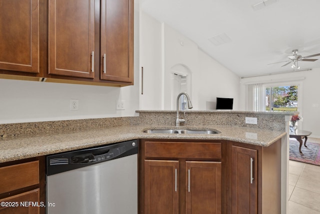 kitchen featuring visible vents, dishwasher, a peninsula, light stone countertops, and a sink