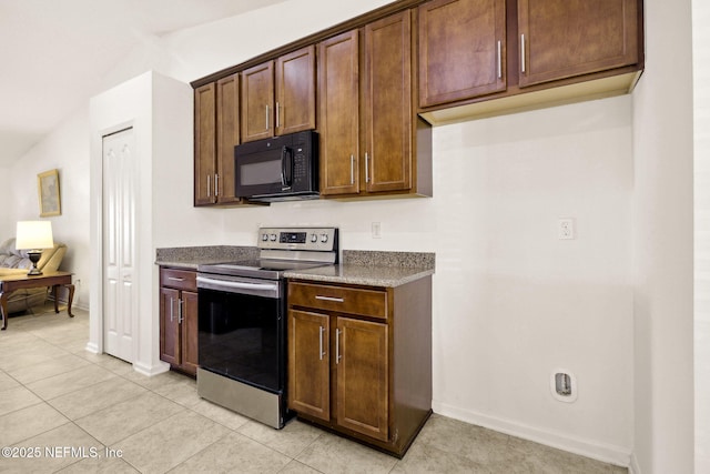 kitchen featuring black microwave, light tile patterned floors, baseboards, electric stove, and dark stone counters