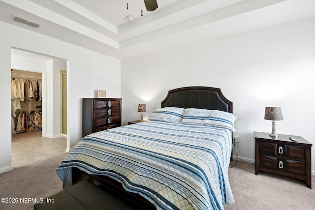 carpeted bedroom featuring baseboards, a spacious closet, visible vents, and a closet