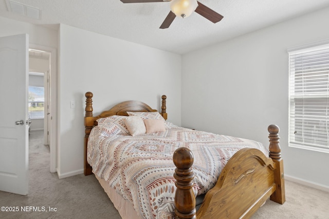 bedroom with carpet floors, visible vents, and baseboards