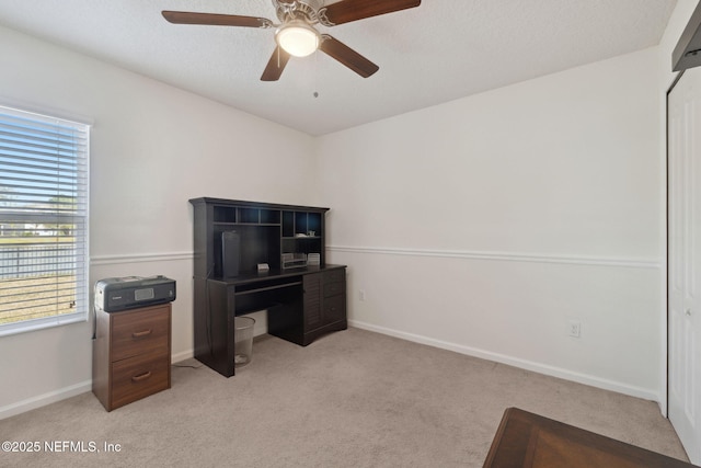 home office with light carpet, baseboards, and a ceiling fan