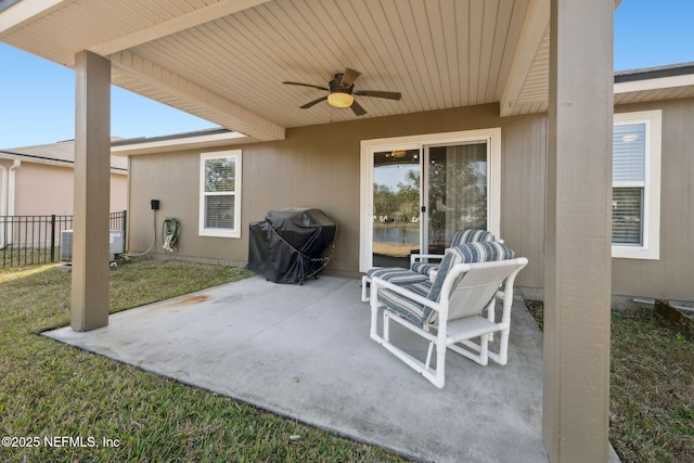 view of patio featuring ceiling fan, fence, and a grill