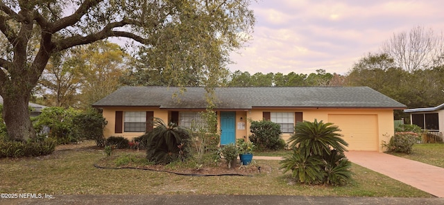 ranch-style house with driveway, an attached garage, and stucco siding