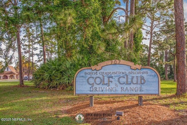 community / neighborhood sign with a yard