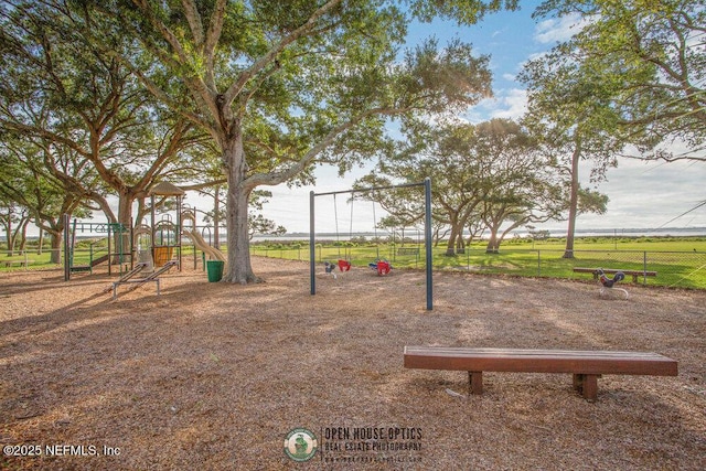 exterior space featuring playground community and fence