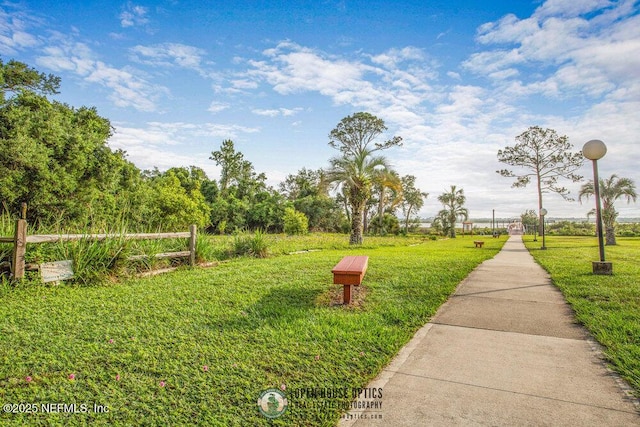 view of property's community with a yard