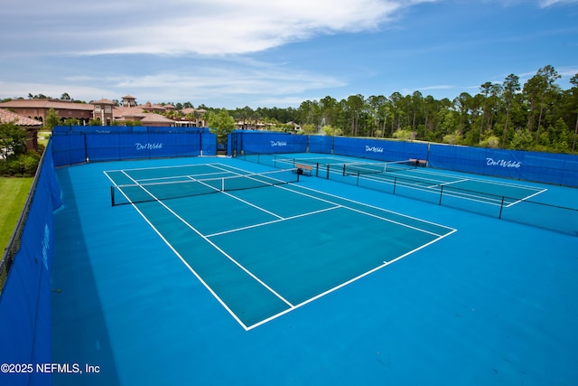 view of sport court featuring fence