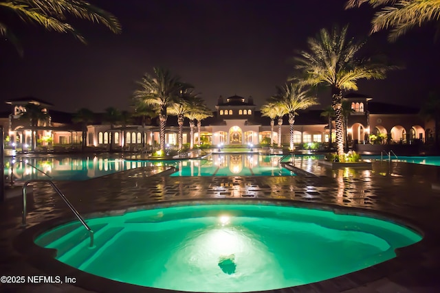 view of pool at night