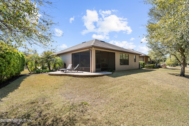 back of property featuring a sunroom, a lawn, and a patio area