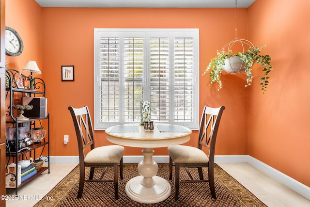 dining space featuring tile patterned flooring and baseboards