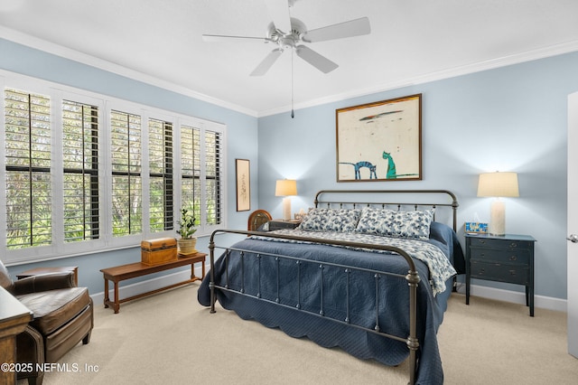 carpeted bedroom with baseboards, ceiling fan, and crown molding