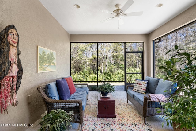 sunroom / solarium featuring ceiling fan