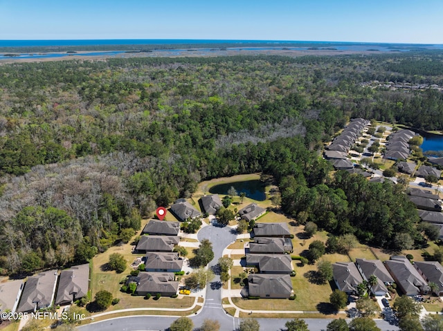 aerial view featuring a residential view, a water view, and a wooded view