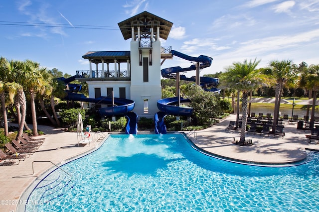 pool featuring a patio and a water slide