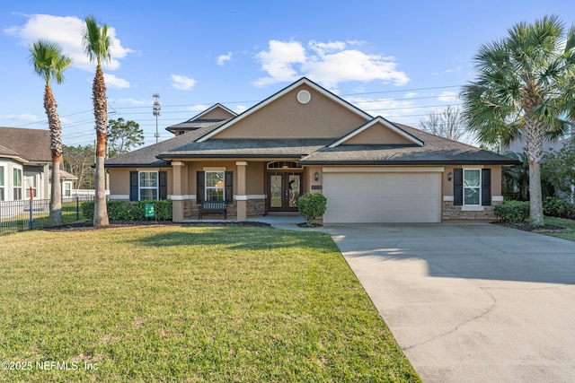 view of front of property with fence, an attached garage, stucco siding, a front lawn, and french doors