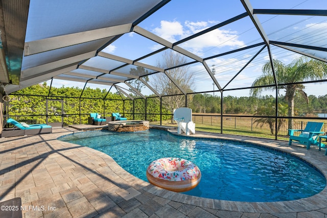 view of pool with glass enclosure, a patio, and a pool with connected hot tub