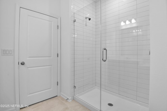 full bath featuring tile patterned floors and a stall shower