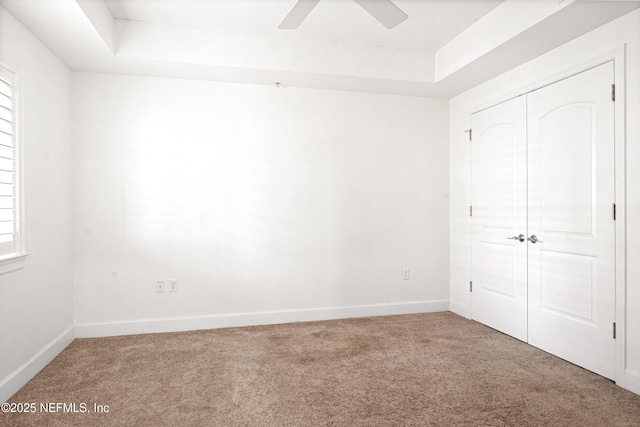 525 3rd St N Unit 303, Jacksonville Beach, FL 32250 - unfurnished bedroom with a closet, a raised ceiling, carpet flooring, and baseboards