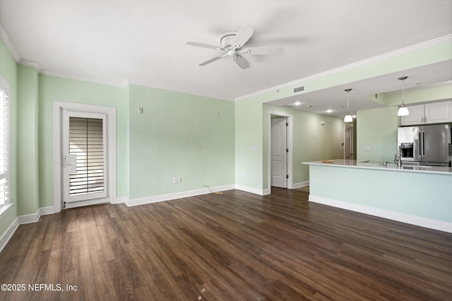 525 3rd St N Unit 303, Jacksonville Beach, FL 32250 - unfurnished living room featuring crown molding, baseboards, and dark wood-style flooring